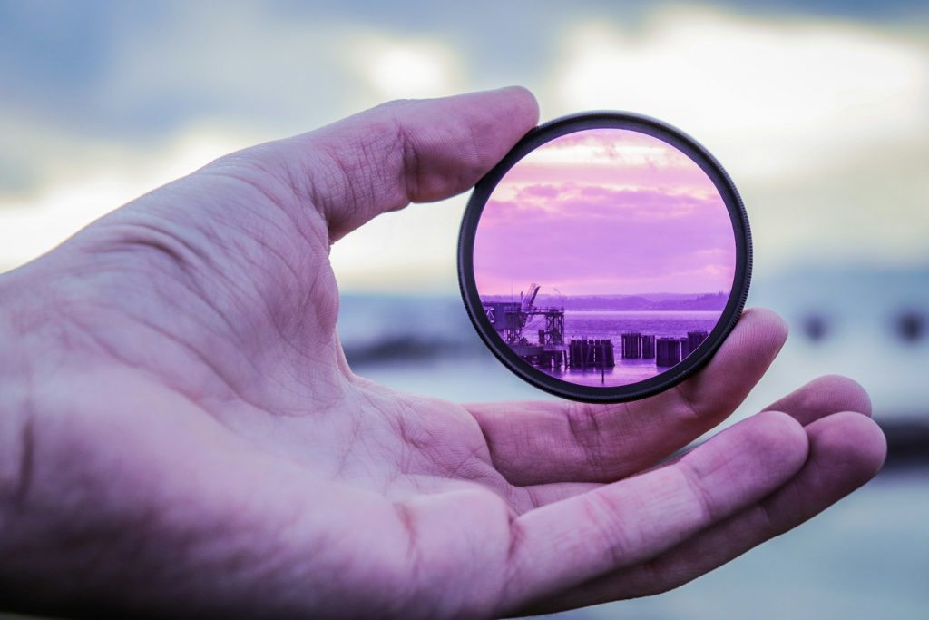 person holding lens